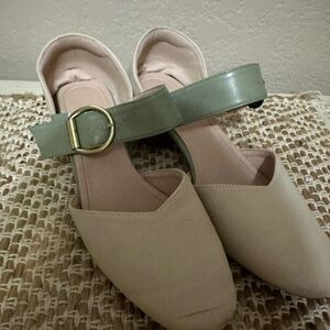 Beige low heels with green buckle strap